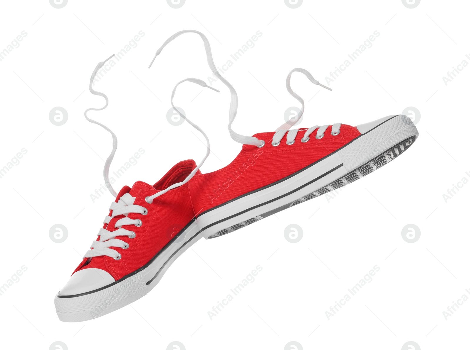 Photo of Pair of red classic old school sneakers on white background