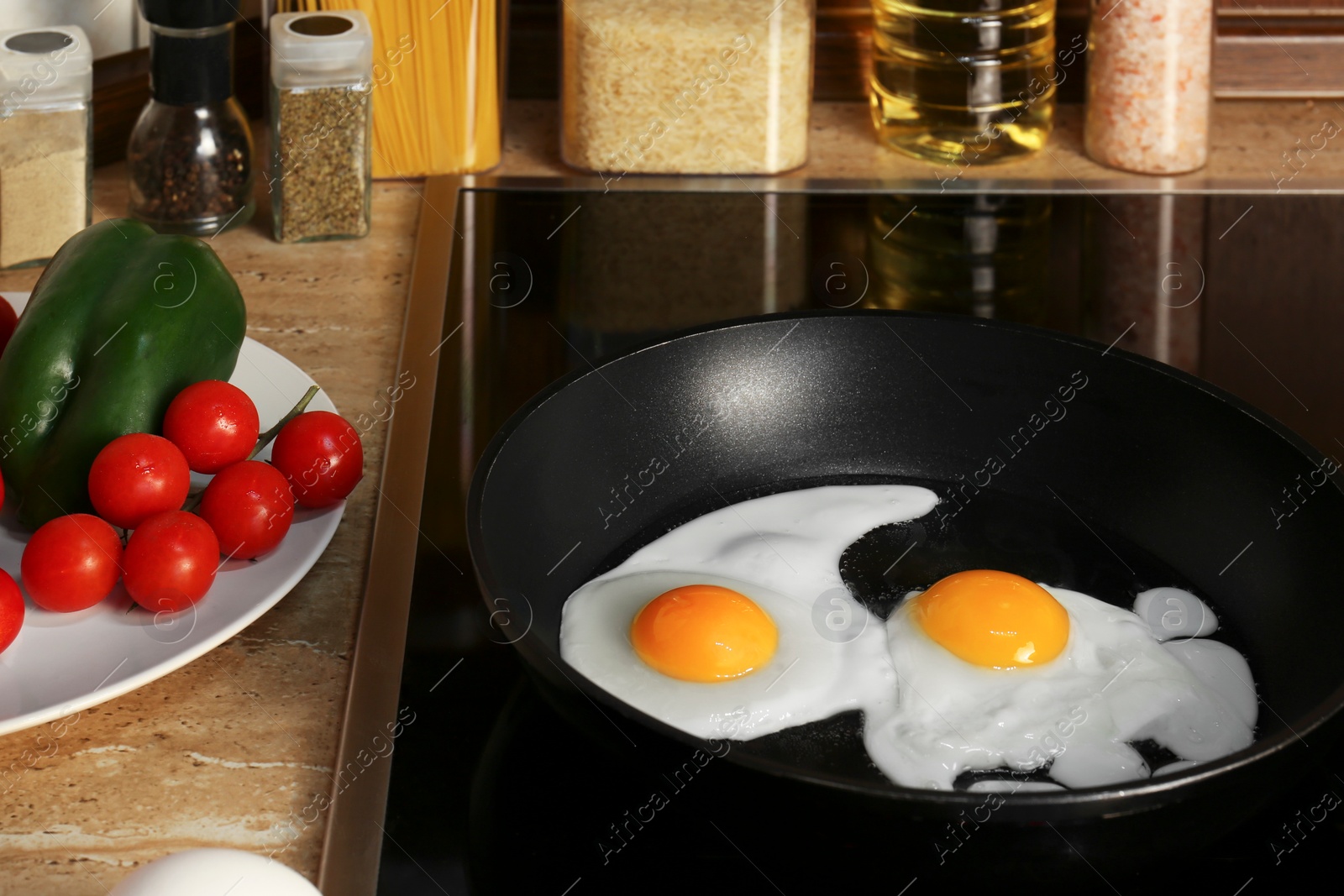 Photo of Cooking eggs for breakfast in frying pan on cooktop