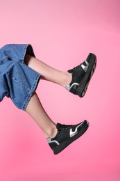 Photo of Woman in stylish shoes on color background, closeup