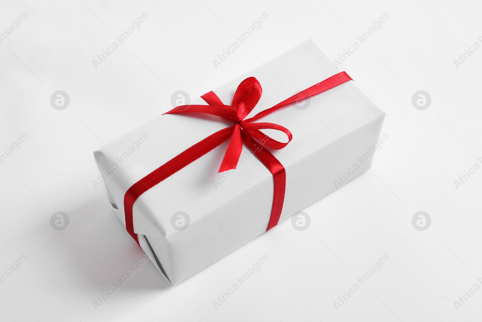 Photo of Beautifully wrapped gift box on white background