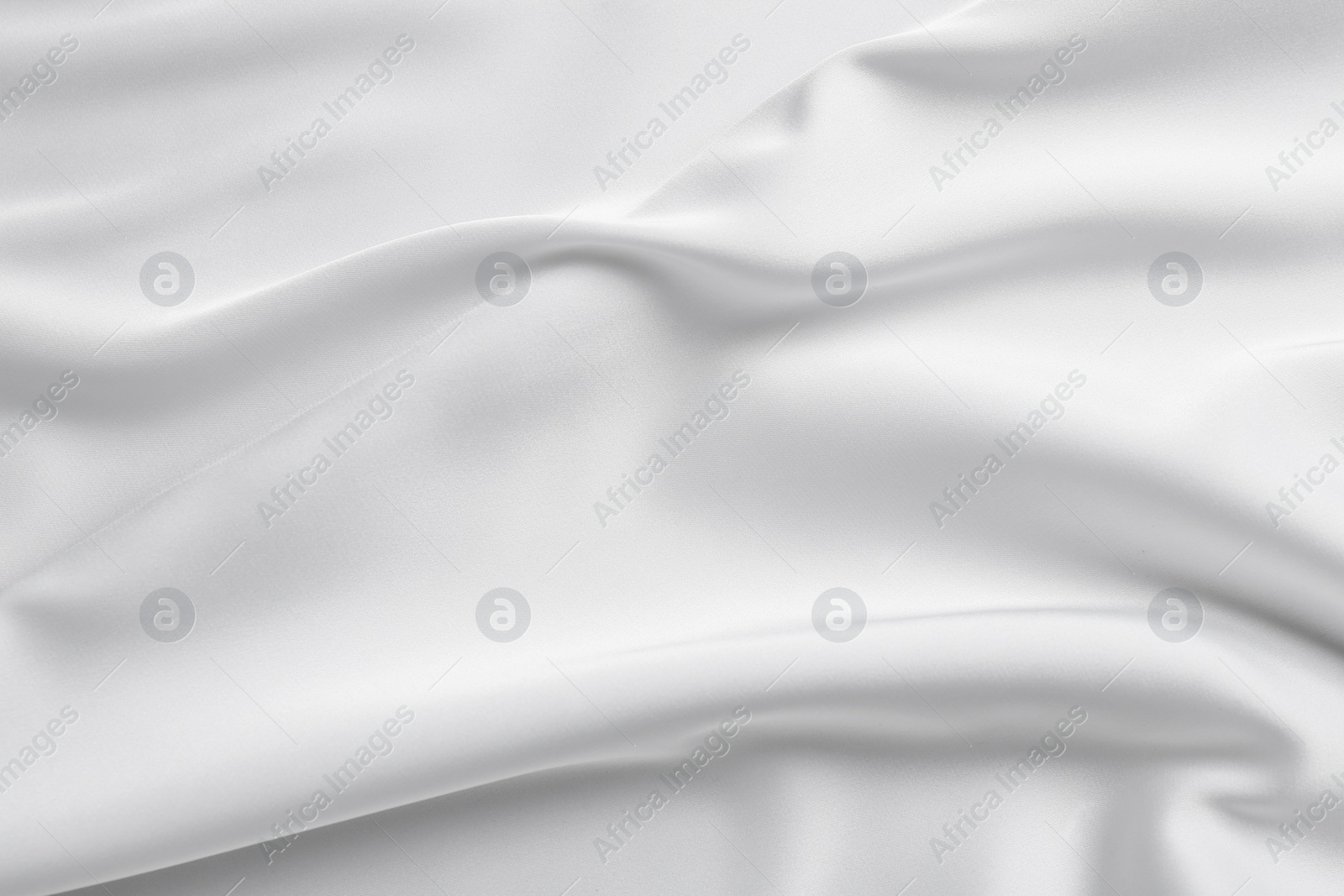 Photo of Texture of white silk ripple fabric as background, top view