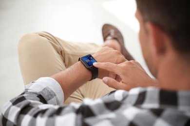 Image of Man with smart watch indoors, closeup view