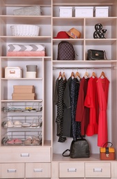 Photo of Large wardrobe with different clothes and home stuff