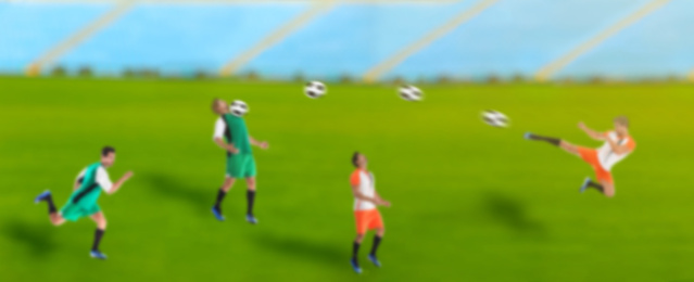 Blurred view of men playing football at stadium, banner design. Soccer match