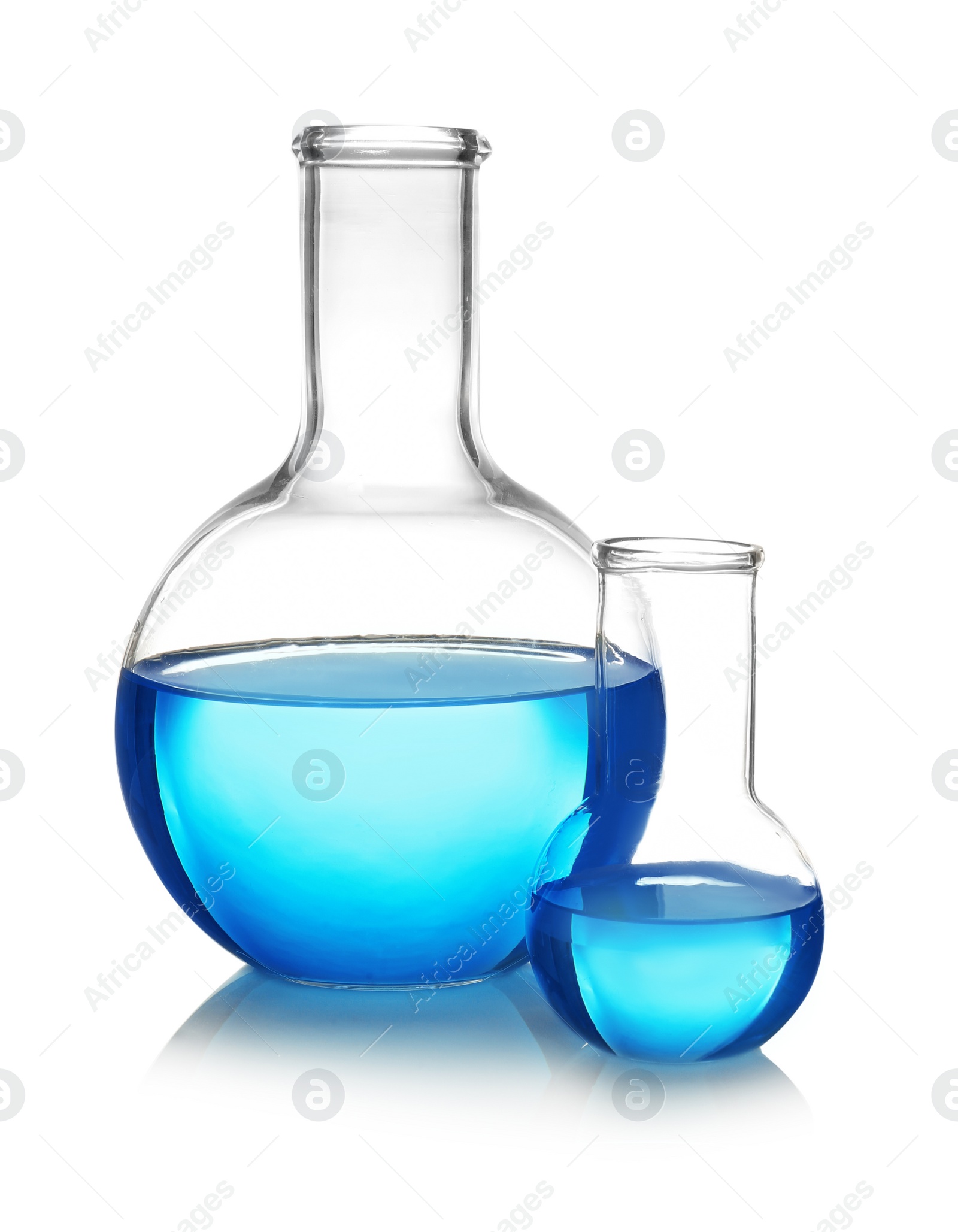 Photo of Flasks with blue liquid on table against white background. Laboratory analysis