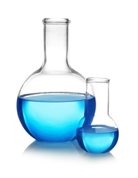 Flasks with blue liquid on table against white background. Laboratory analysis