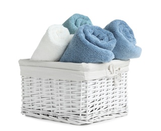 Basket with rolled towels isolated on white