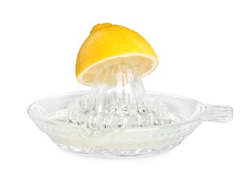 Photo of Glass squeezer and halved fresh lemon on white background