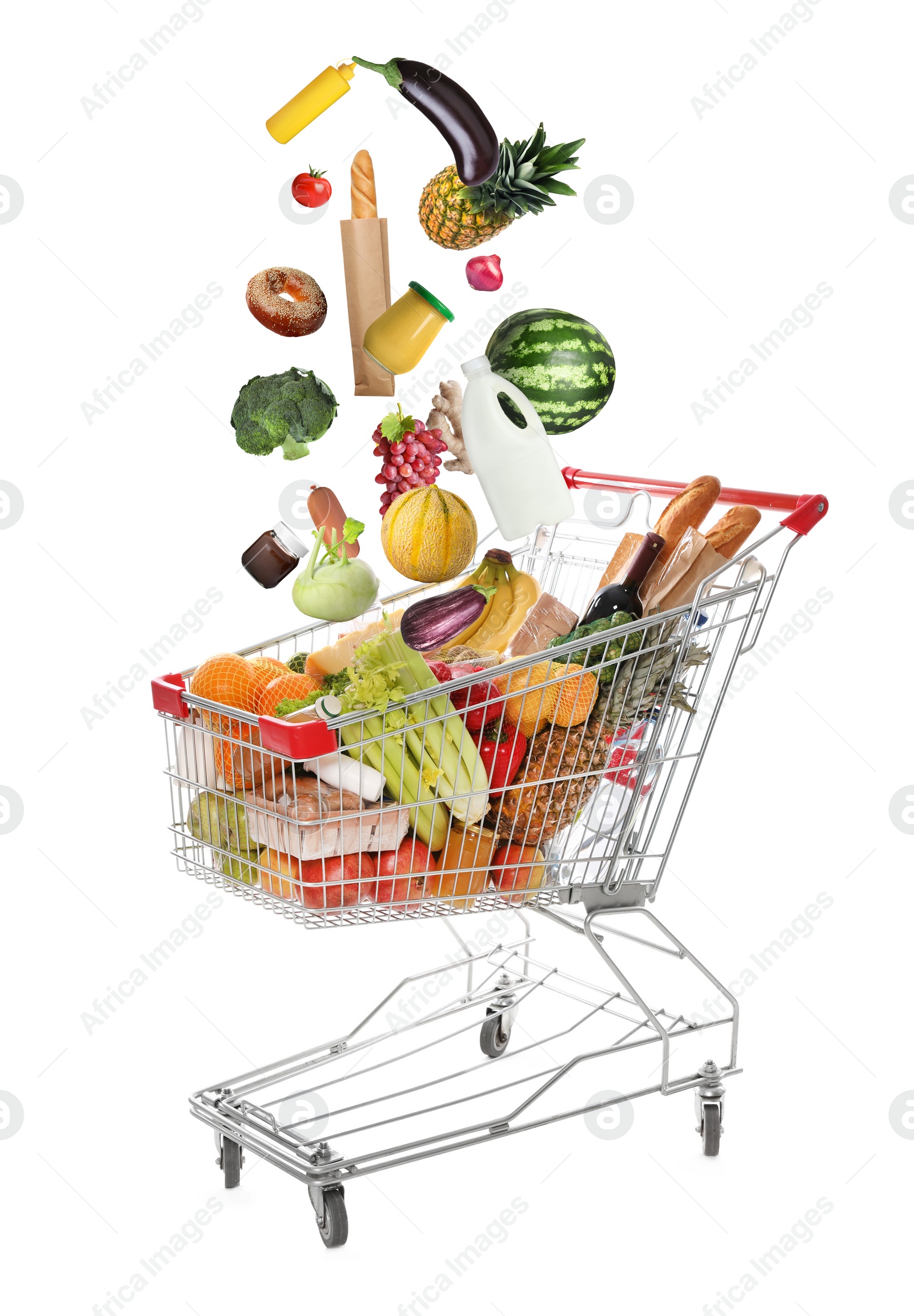 Image of Market assortment. Different products falling into shopping cart on white background