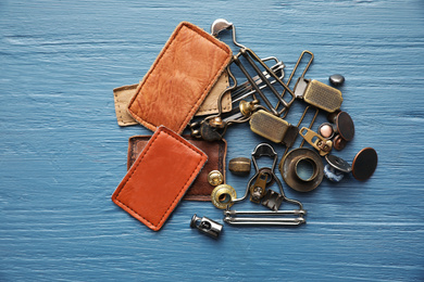 Flat lay composition with garment accessories for jeans on light blue wooden background