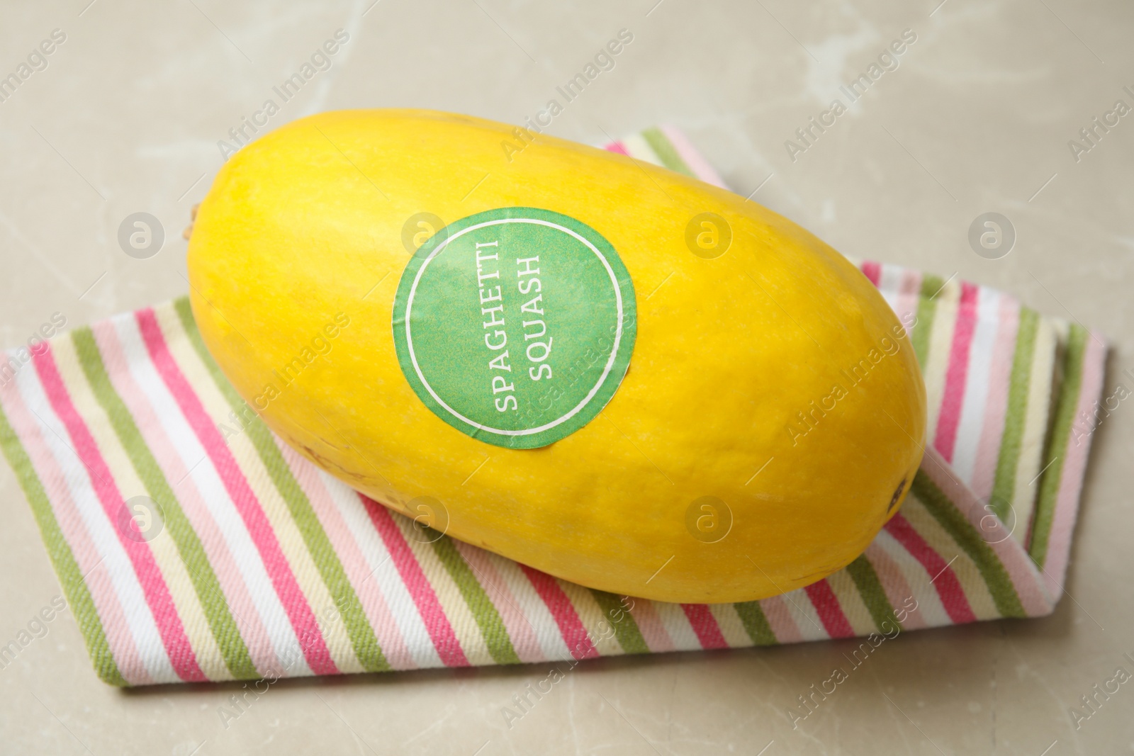 Photo of Whole ripe spaghetti squash on gray table