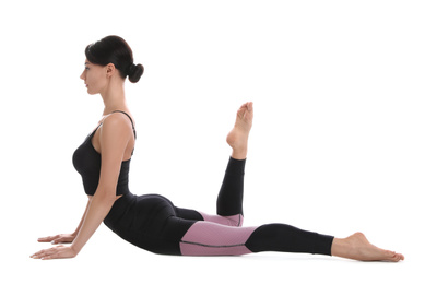 Professional young acrobat exercising on white background