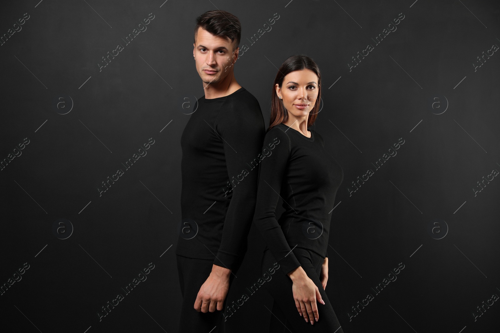 Photo of Couple wearing thermal underwear on black background