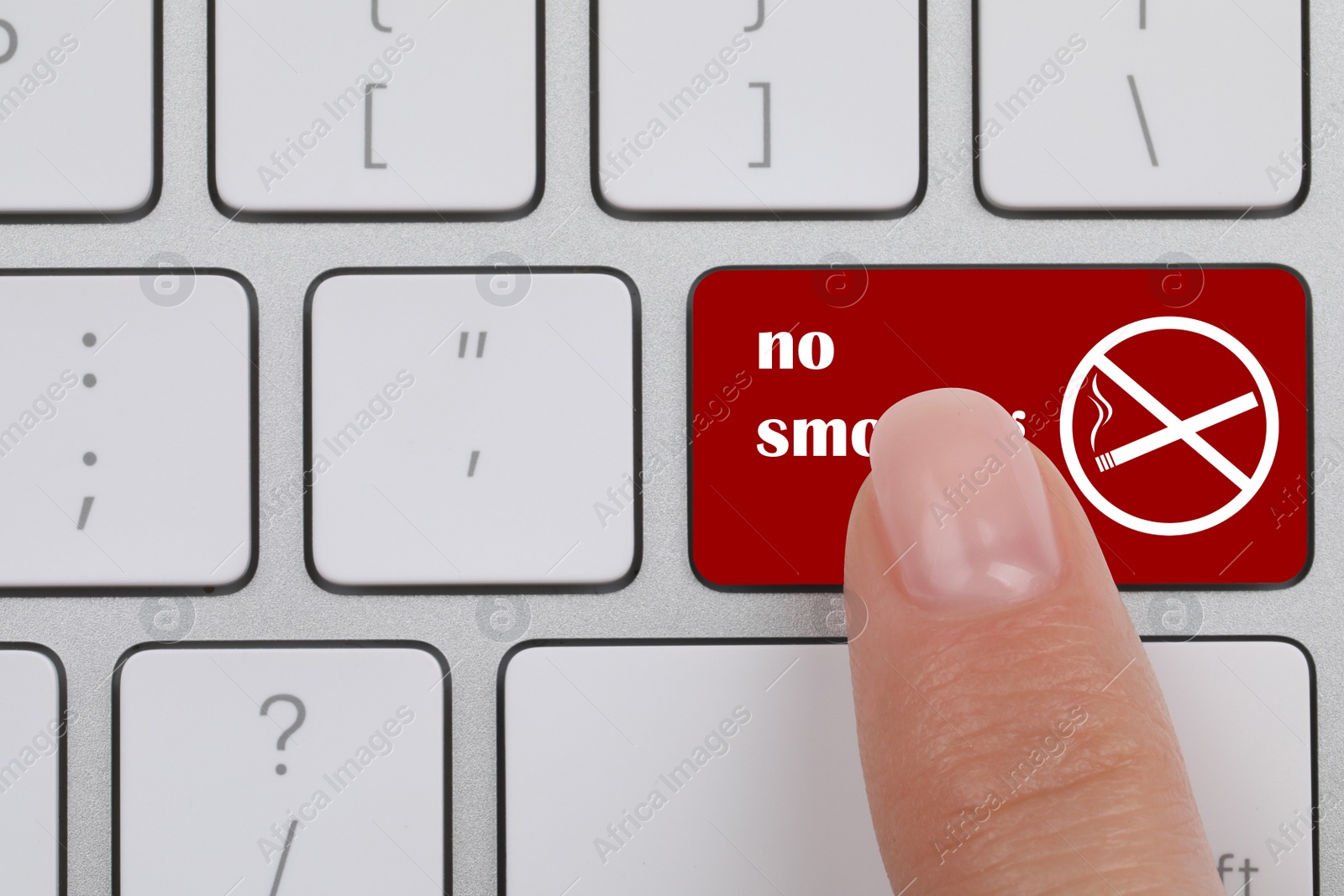 Image of Top view of woman pressing red button with phrase No Smoking on computer keyboard, closeup