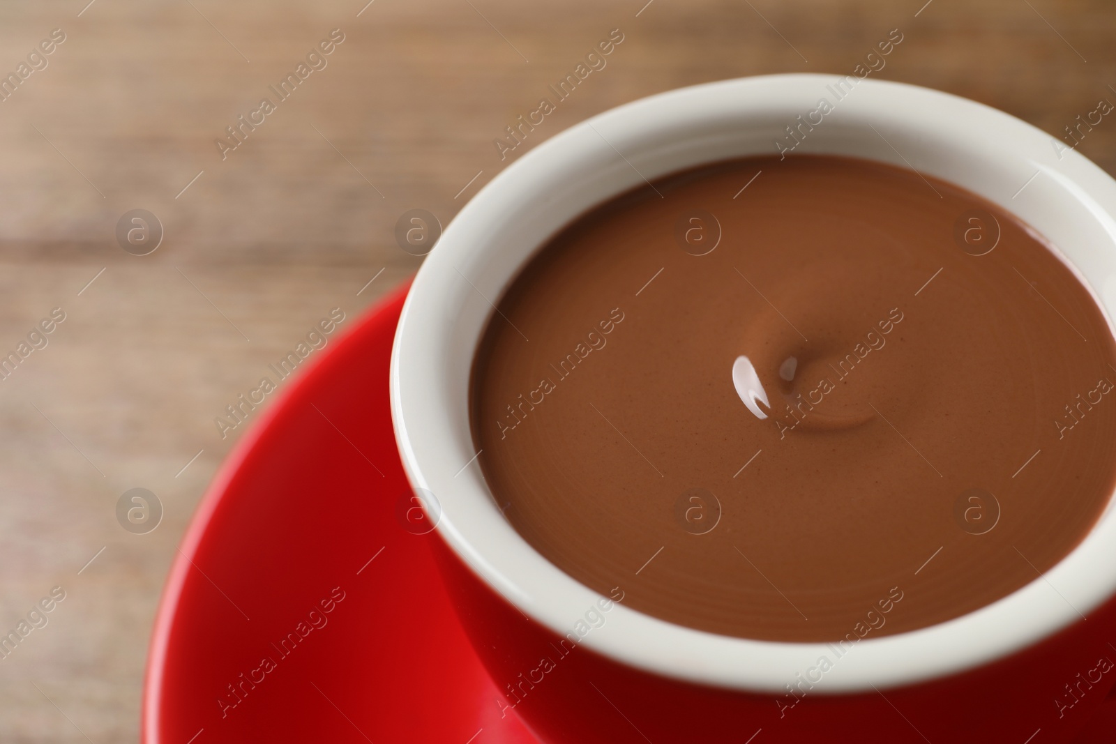 Photo of Yummy hot chocolate in cup on table, closeup. Space for text