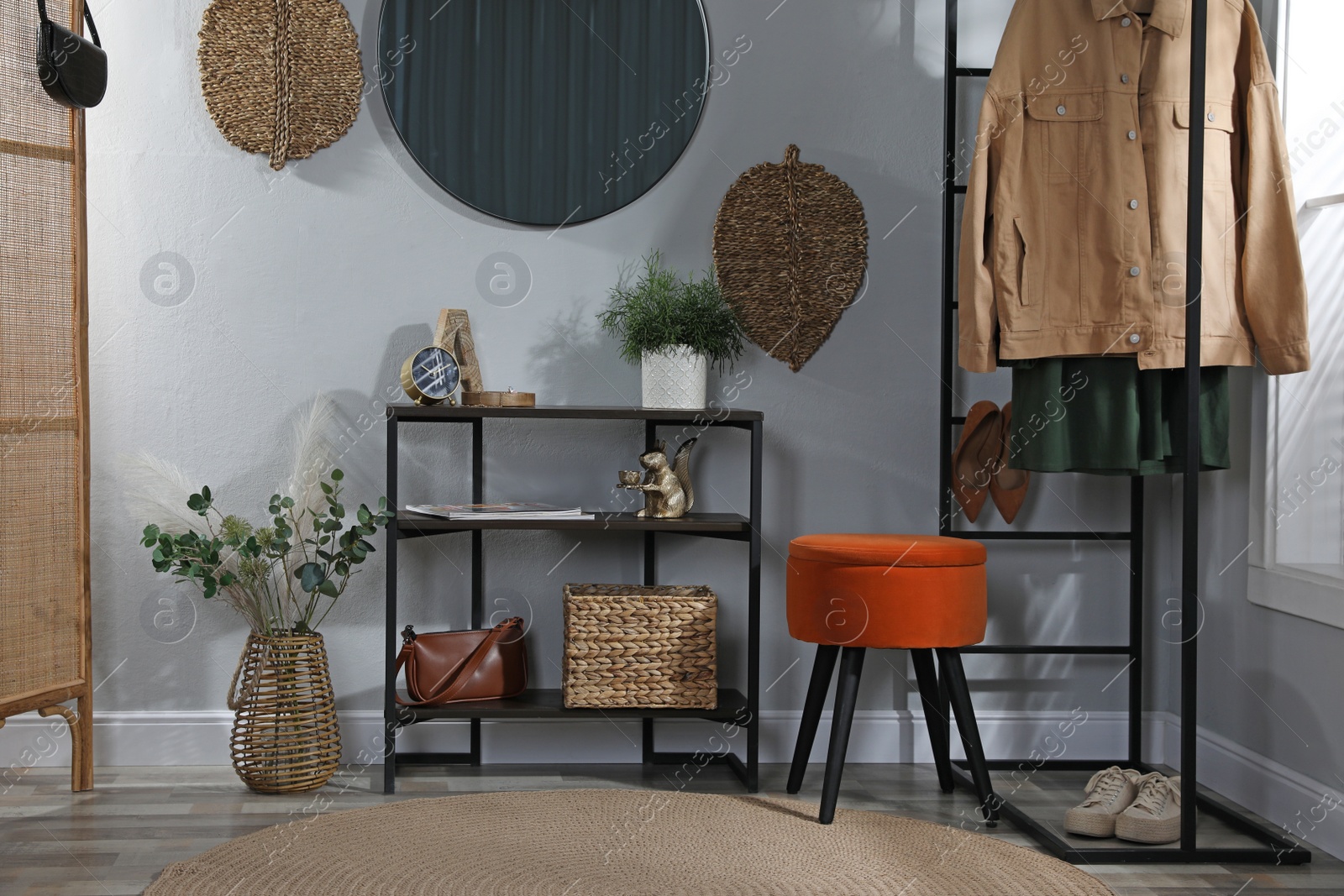 Photo of Stylish room interior with console table and beautiful decor elements