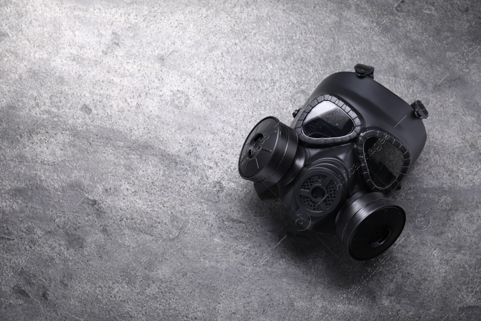 Photo of One gas mask on grey textured background, top view. Space for text