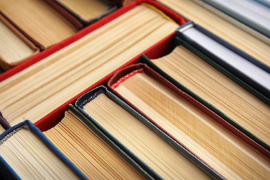 Many different hardcover books as background, closeup