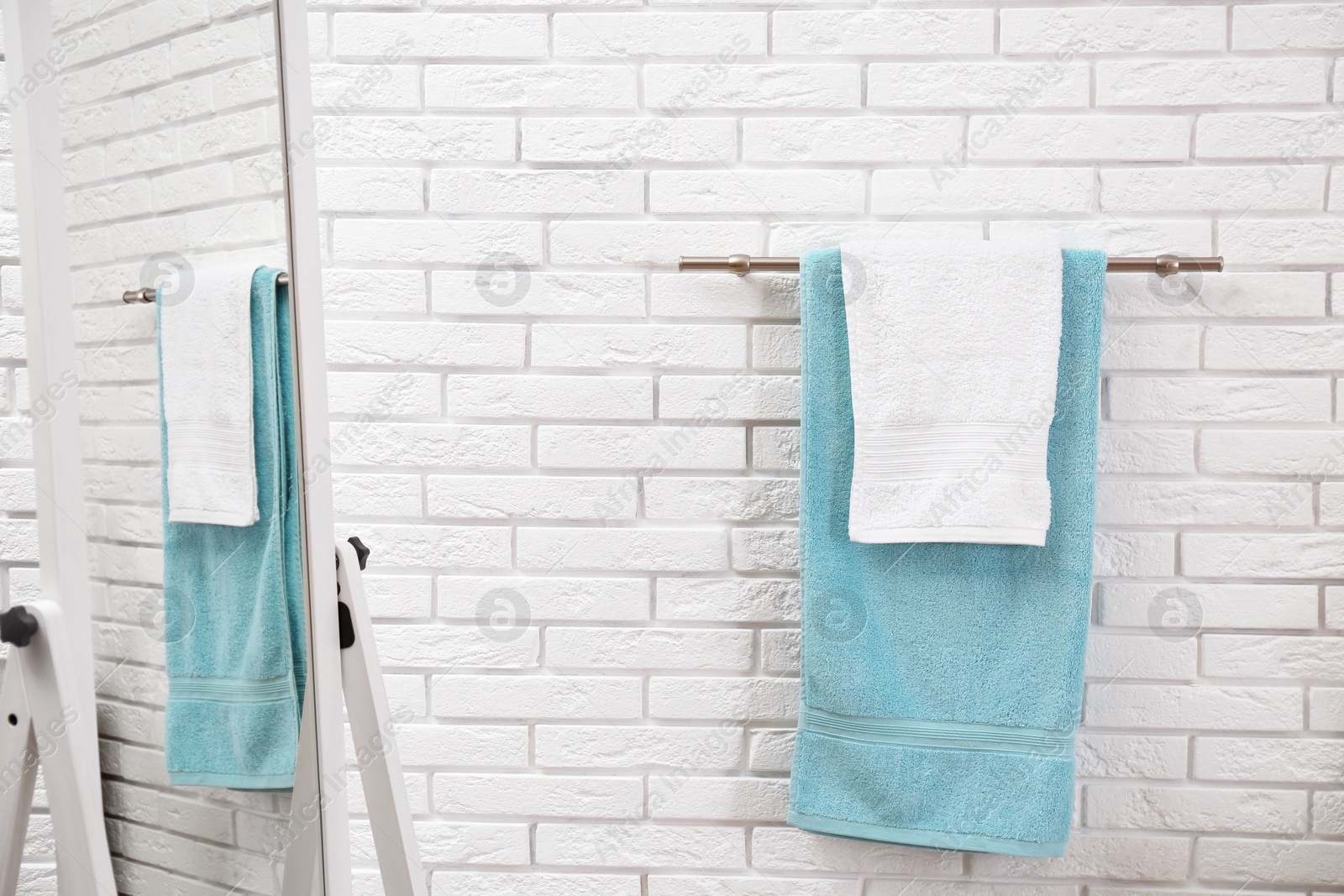 Photo of Fresh clean towels on hanger in bathroom