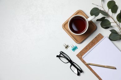 Photo of Flat lay composition with ceramic mug of aromatic tea and eucalyptus branch on white background. Space for text