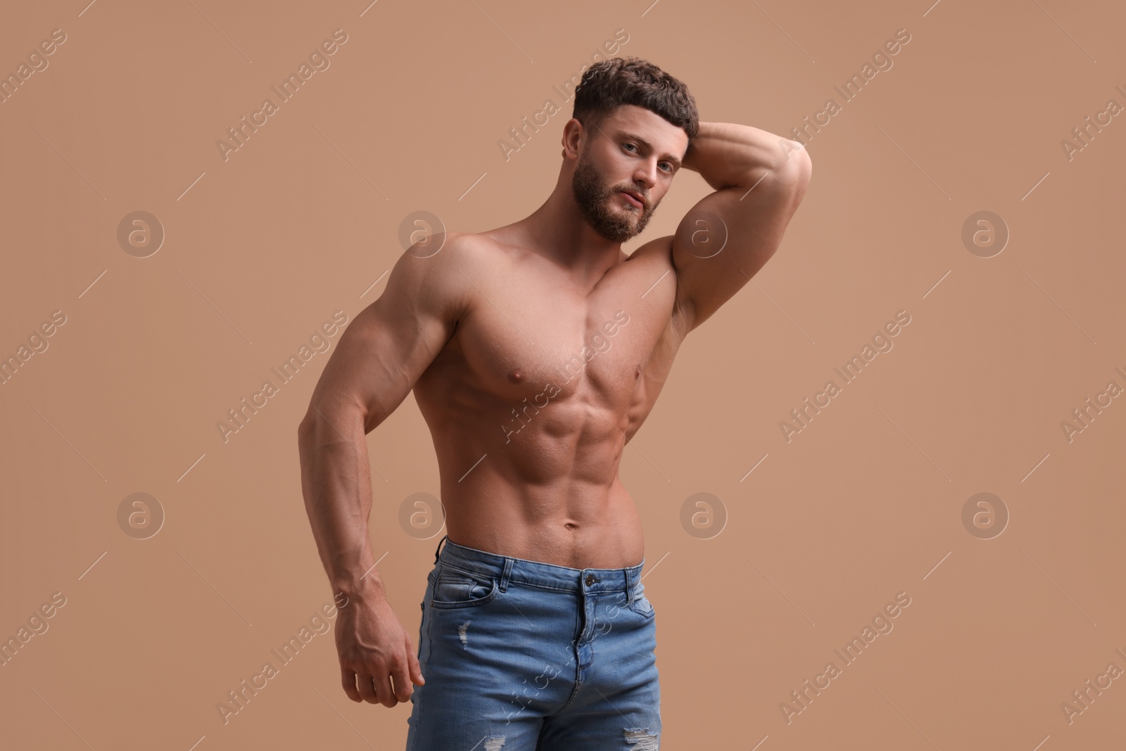 Photo of Handsome muscular man on beige background. Sexy body