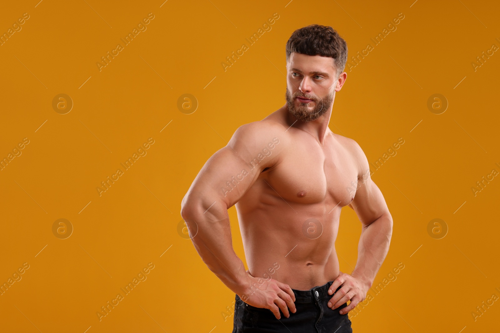 Photo of Handsome muscular man on orange background, space for text. Sexy body