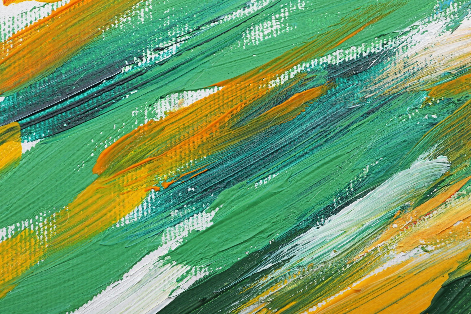 Photo of Beautiful strokes of colorful oil paints on white canvas as background, closeup