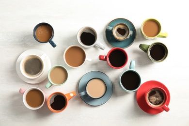 Flat lay composition with cups of coffee on light background. Food photography