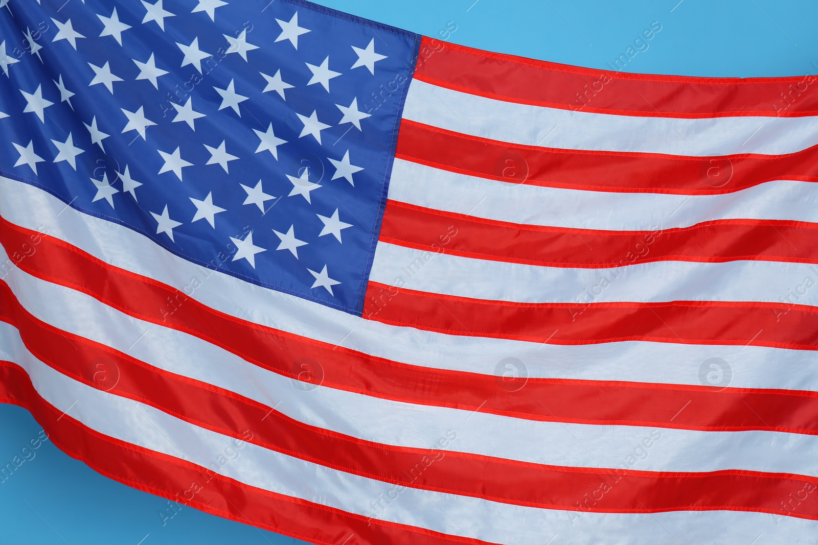 Photo of National United states of America flag on light blue background