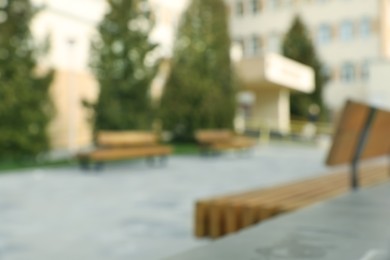 Photo of Blurred view of city street with benches