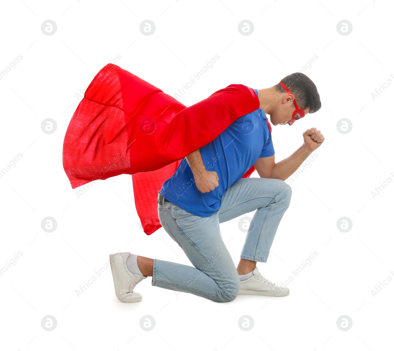 Photo of Man wearing superhero cape and mask on white background