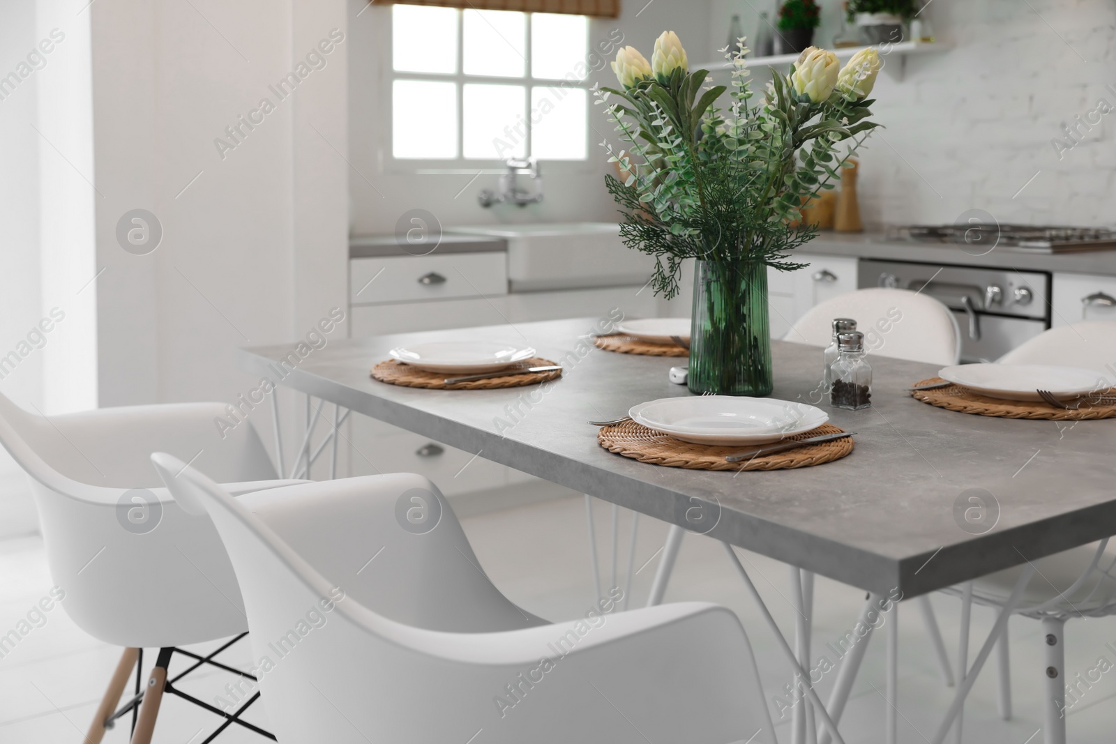 Photo of Elegant table setting in stylish kitchen. Interior design