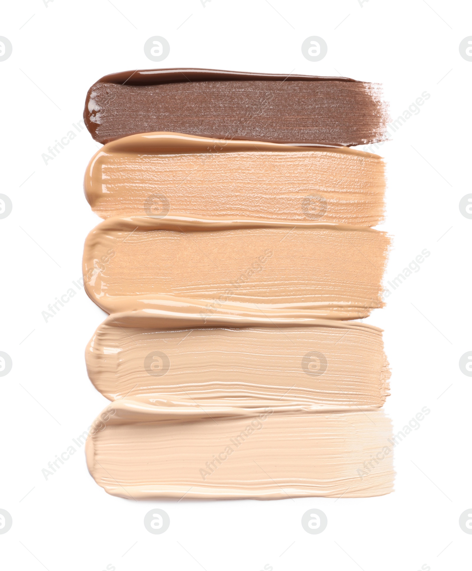 Photo of Samples of skin foundation on white background, top view