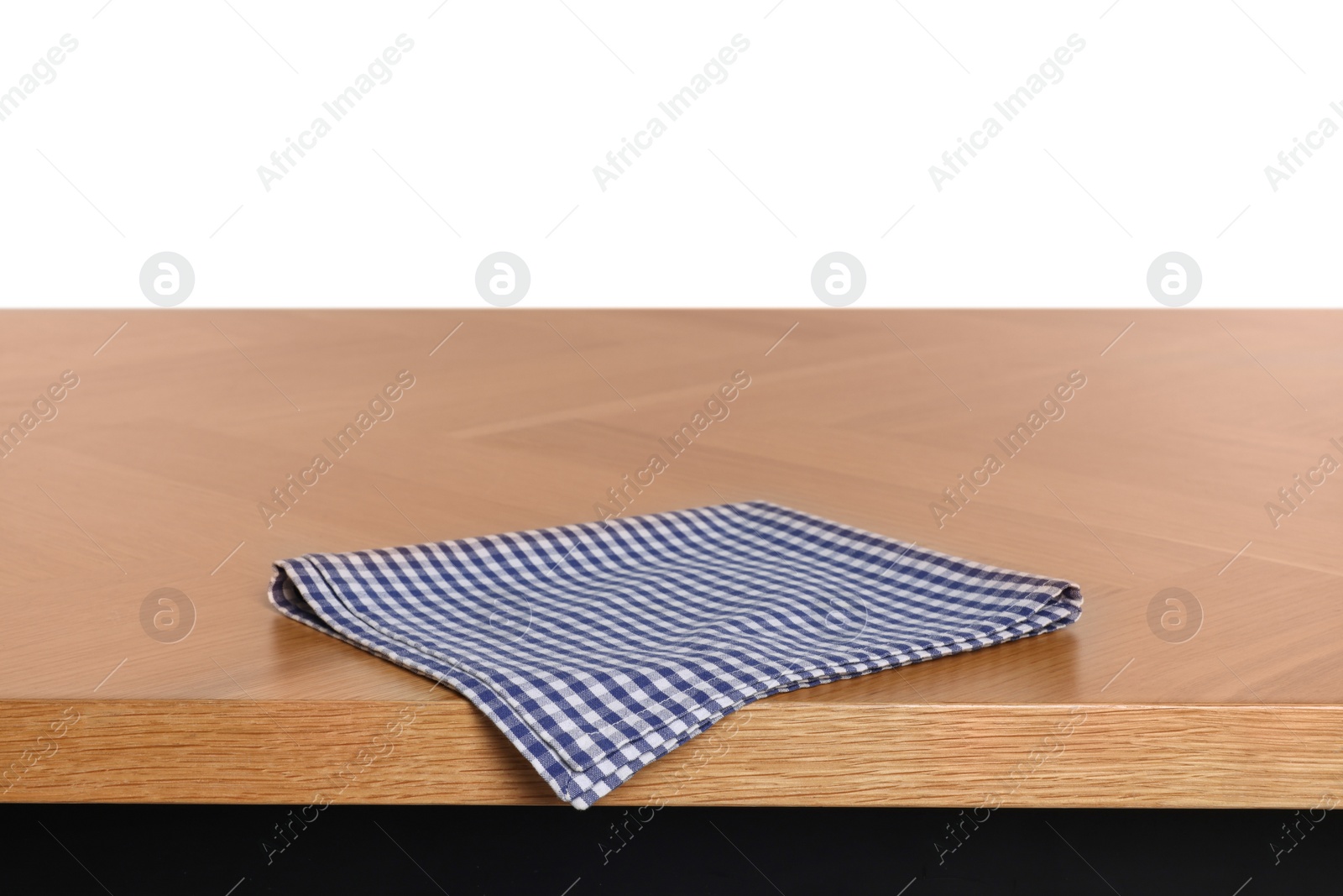 Photo of Checkered tablecloth on wooden table against white background