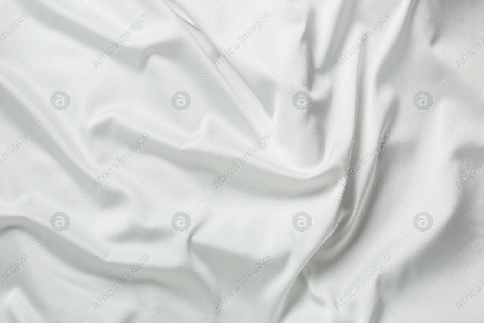 Photo of Texture of white silk ripple fabric as background, top view