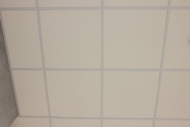 Photo of White ceiling with PVC tiles, view from below