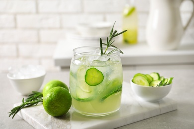 Photo of Jar with fresh lemonade and ingredients on table