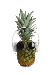 Photo of Funny pineapple with headphones and sunglasses on white background