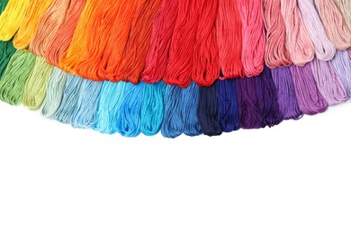 Photo of Set of colorful embroidery threads on white background, top view