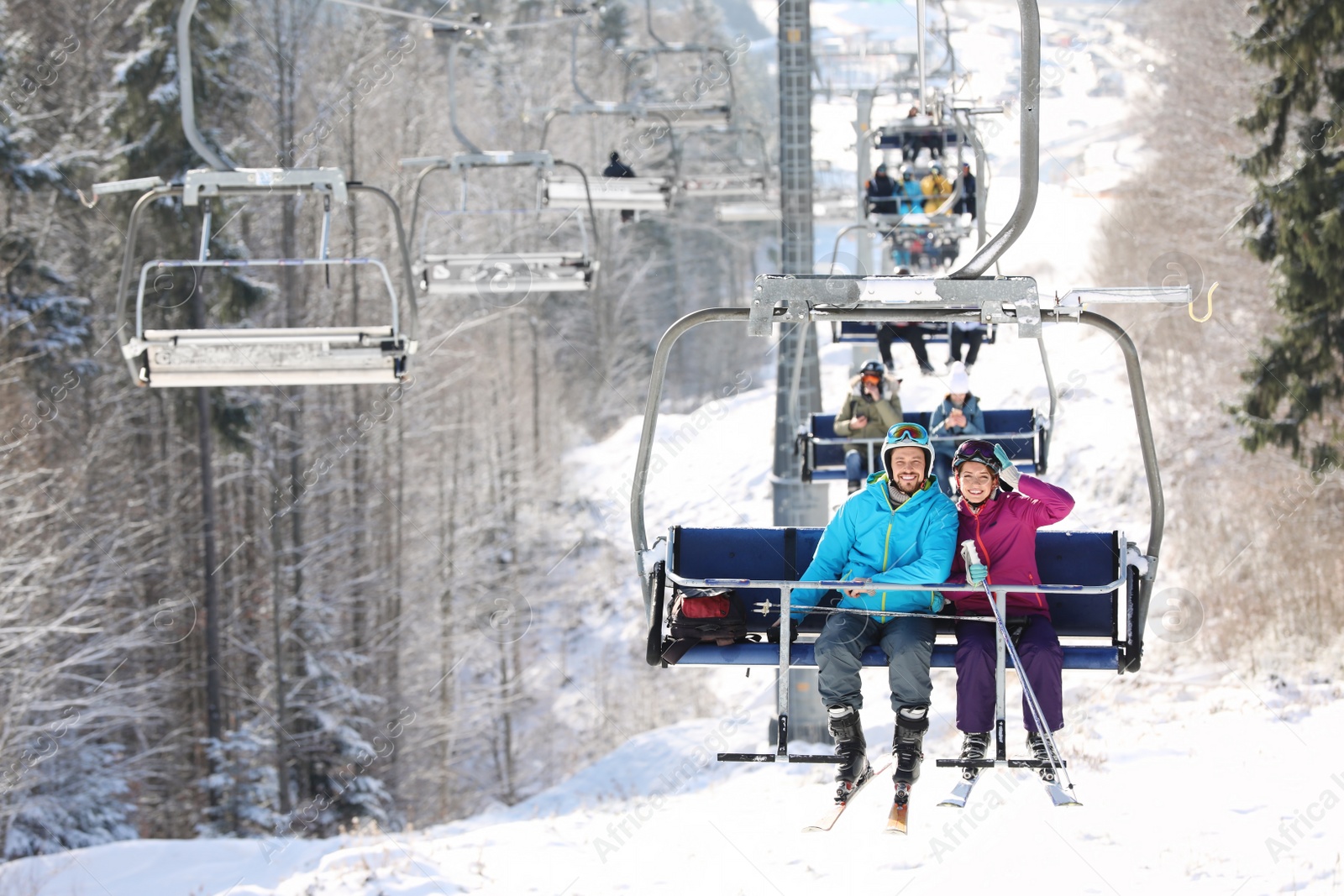 Photo of People using chairlift at mountain ski resort. Winter vacation