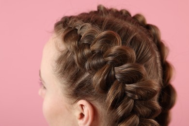 Photo of Woman with braided hair on pink background, closeup
