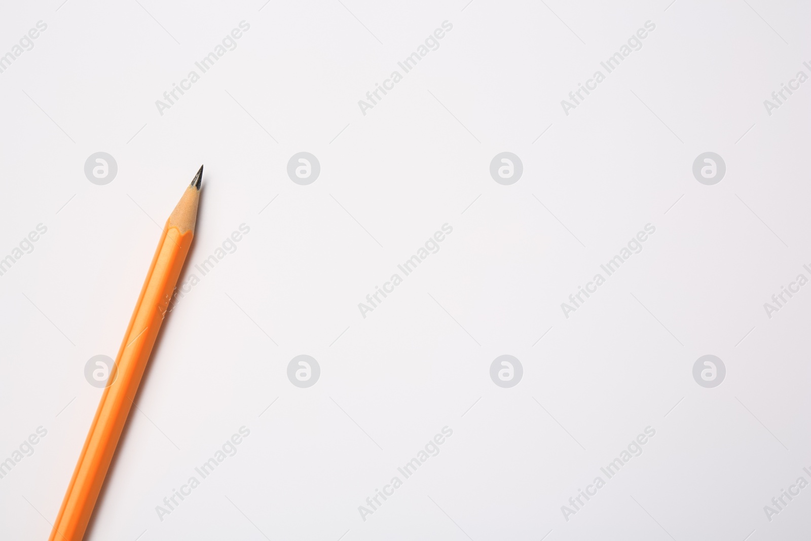 Photo of Sharp graphite pencil on white background, top view. Space for text