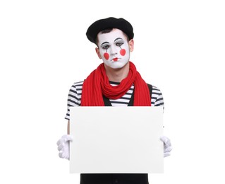 Photo of Sad mime artist with blank sign on white background