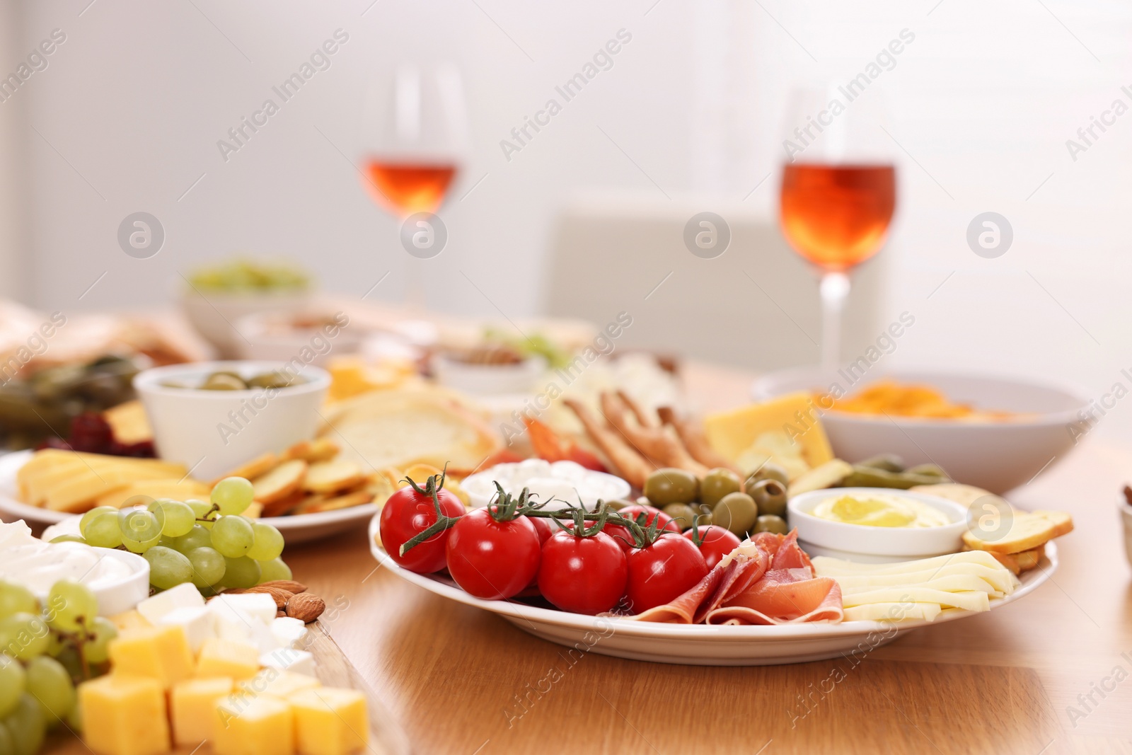 Photo of Assorted appetizers served on wooden table, selective focus. Space for text