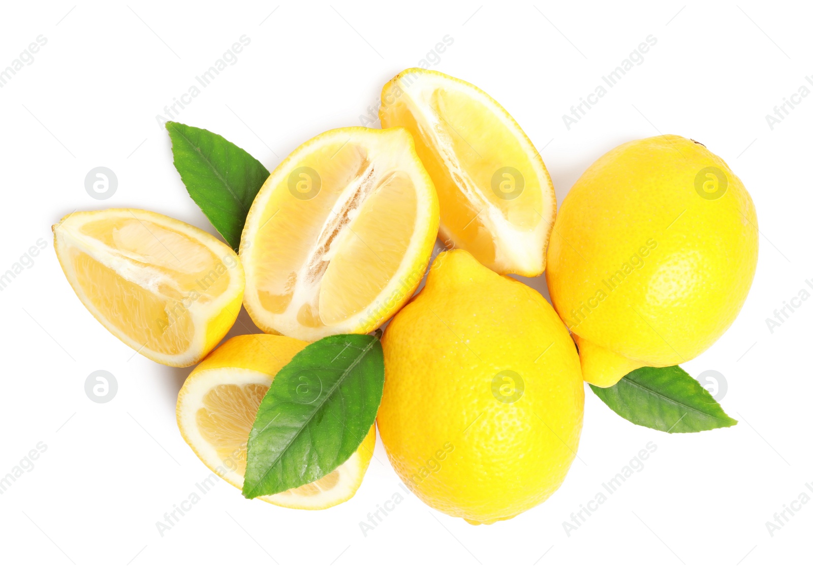 Photo of Cut and whole ripe lemons with green leaves on white background, top view