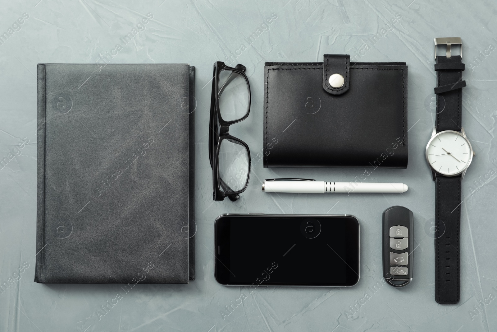 Photo of Flat lay composition with male accessories and remote car key on grey background. Space for text