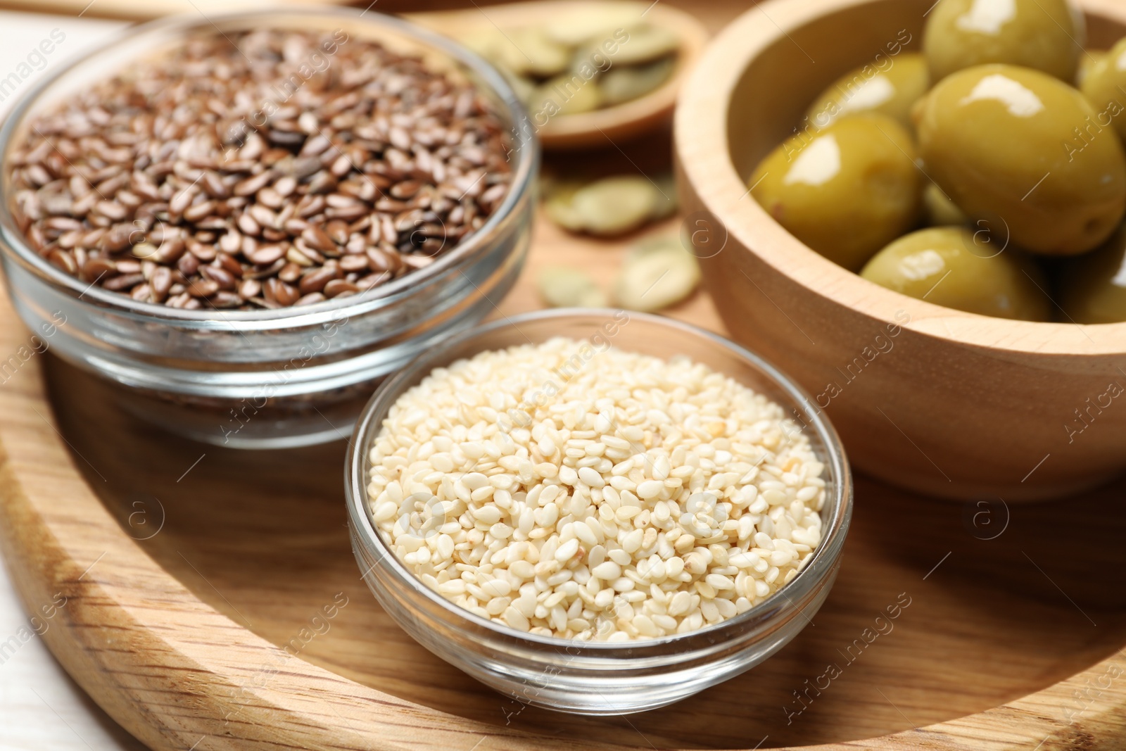 Photo of Different products high in vegetable fats on white table, closeup