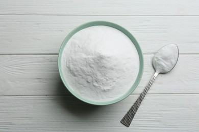Photo of Baking soda on white wooden table, flat lay