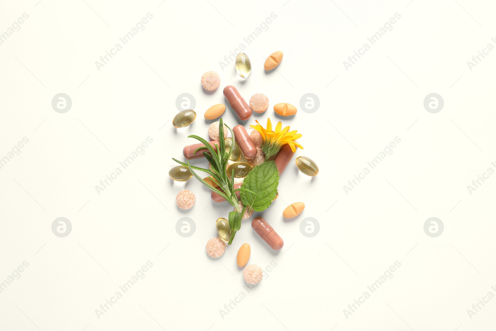 Photo of Different pills, herbs and flower on white background, flat lay. Dietary supplements