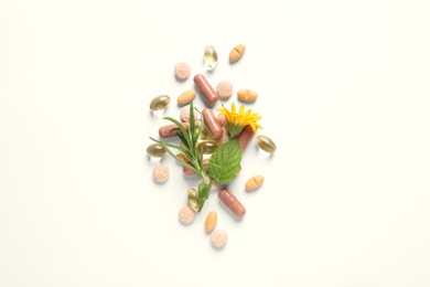 Photo of Different pills, herbs and flower on white background, flat lay. Dietary supplements